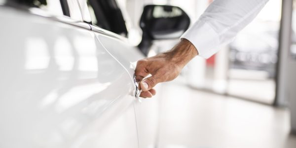 close-up-man-testing-car-dealership